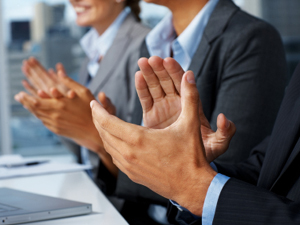 Closeup of business people applauding during a business meeting